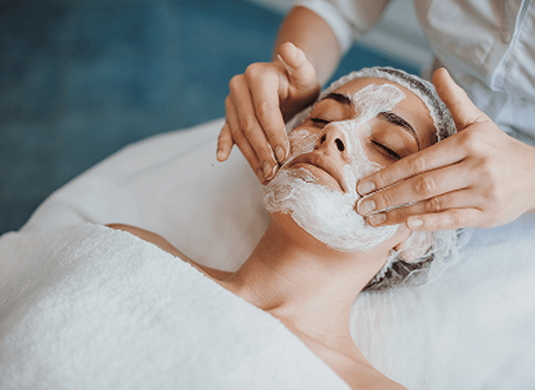 Facial treatment with cream applied at spa.