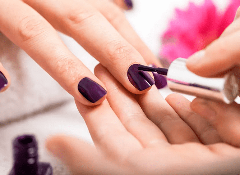 Purple nail polish being applied