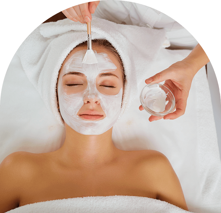 Woman receiving a facial mask treatment.
