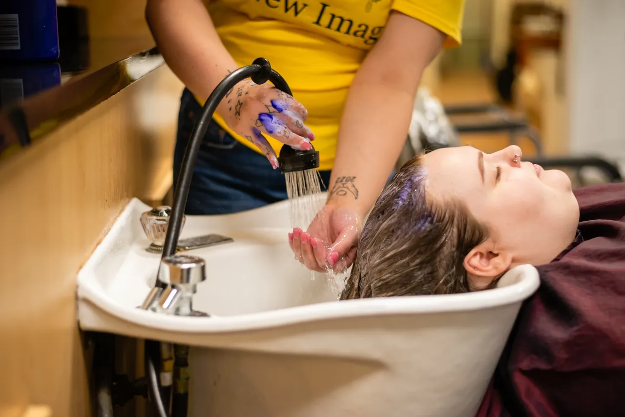 Woman getting hair rinsed