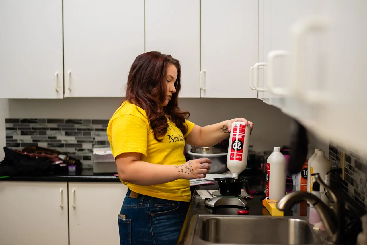 Person pouring liquid into a pan