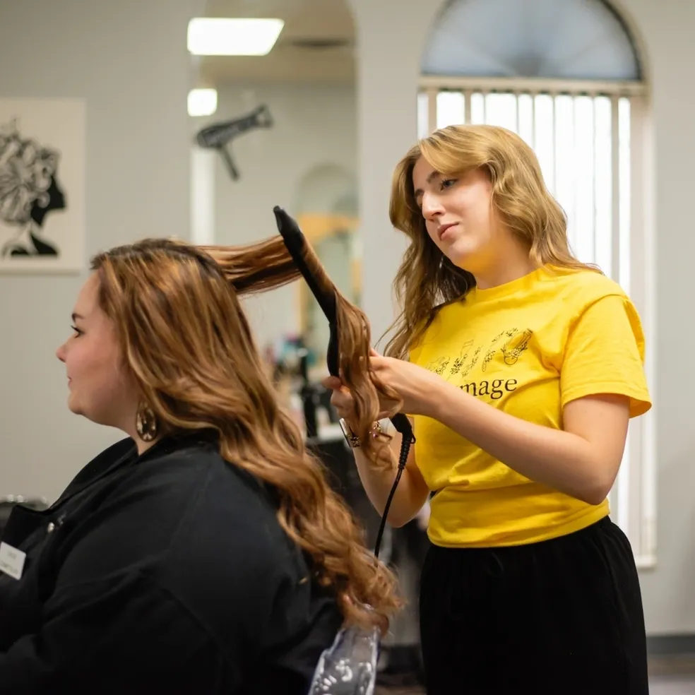 Woman styling hair in salon